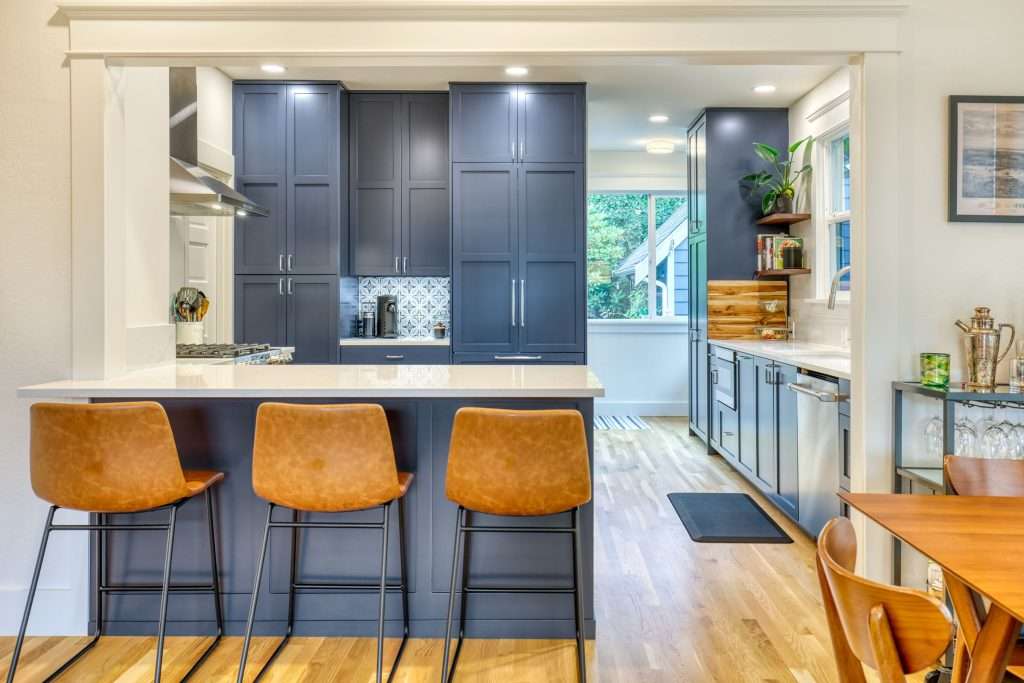 Modern kitchen with navy cabinets and bar stools