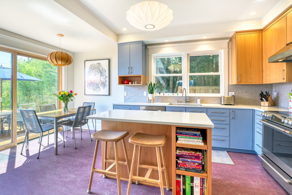 Bright modern kitchen with island and dining area.